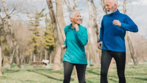 A man and woman are walking in the park.