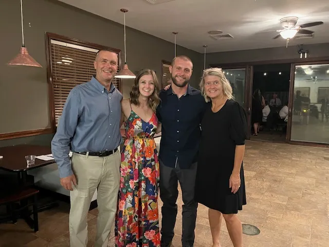 A group of people standing in a room.